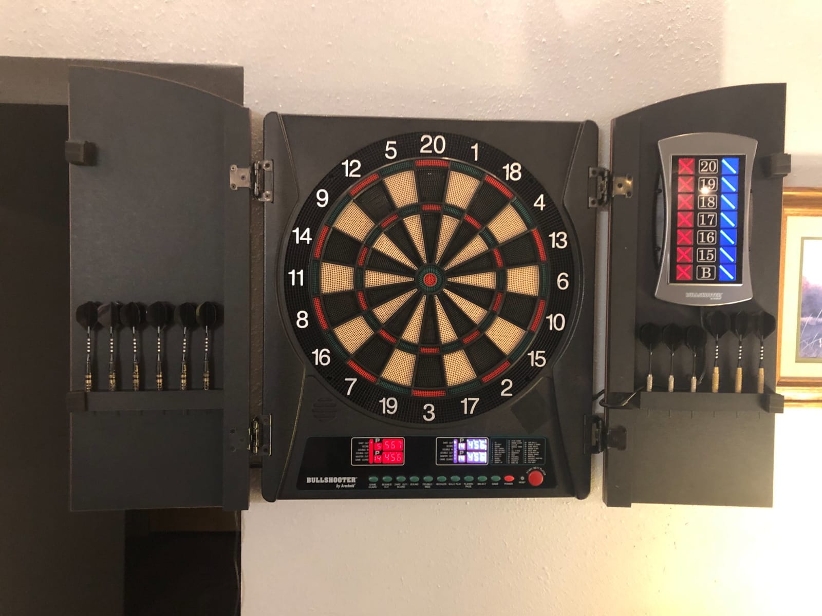 Arachnid CricketMaxx 1.0: 13.5” recreation size with wood cabinet. Features 34 games, 183 variations, 8-player LED X/O scoring, and Heckler mode. Integrated storage for darts and accessories customer photo 1